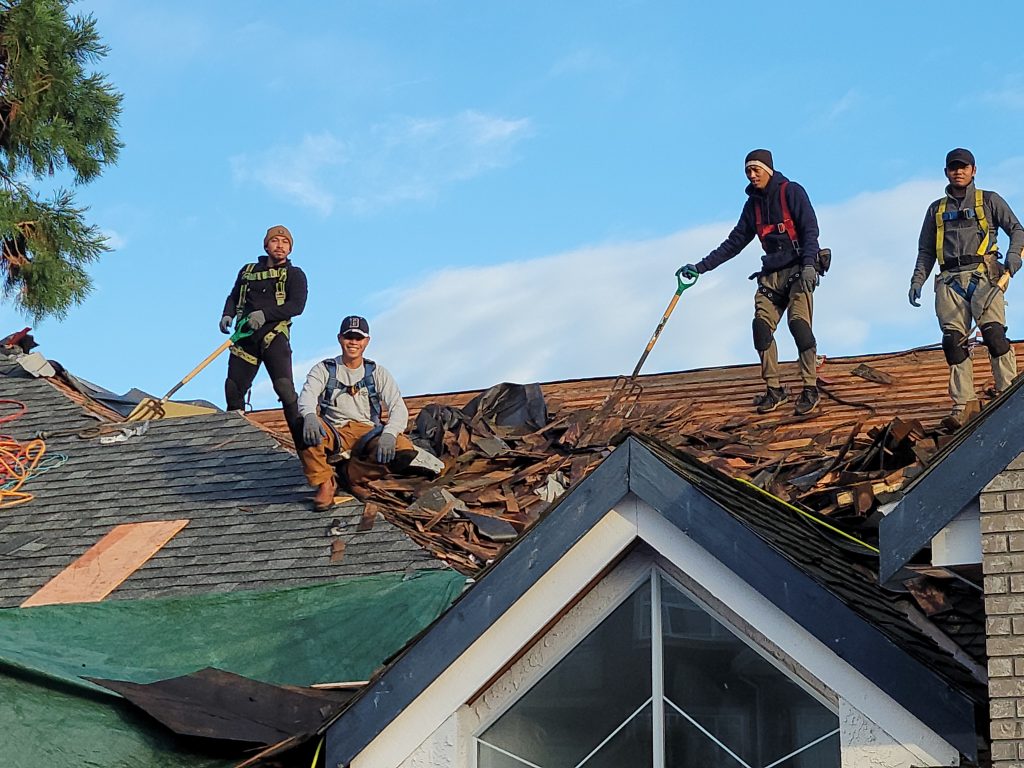 A team of skilled roofers working on a roof in Vancouver.