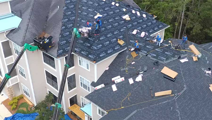 a group of people working on a roof.