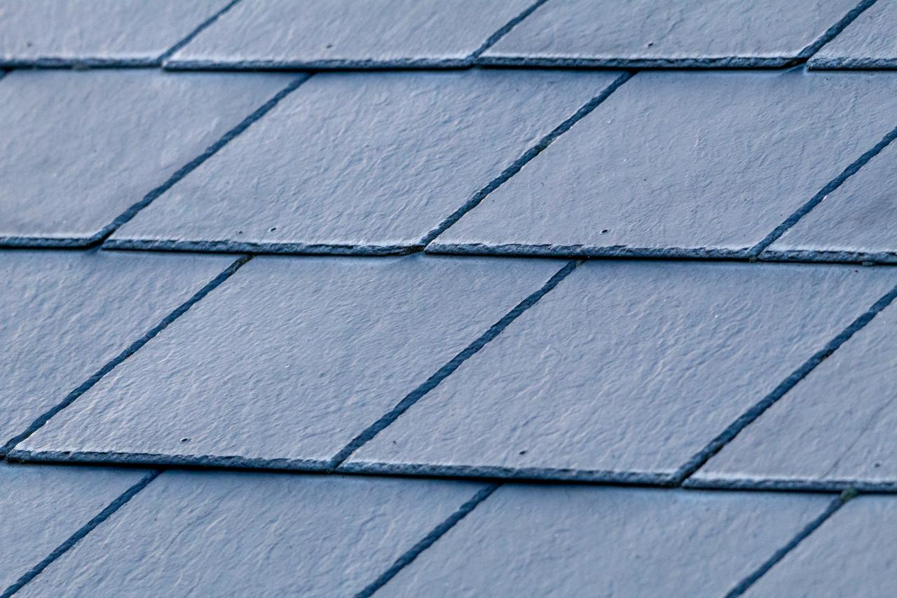 A detailed close up of a vibrant blue tiled roof.