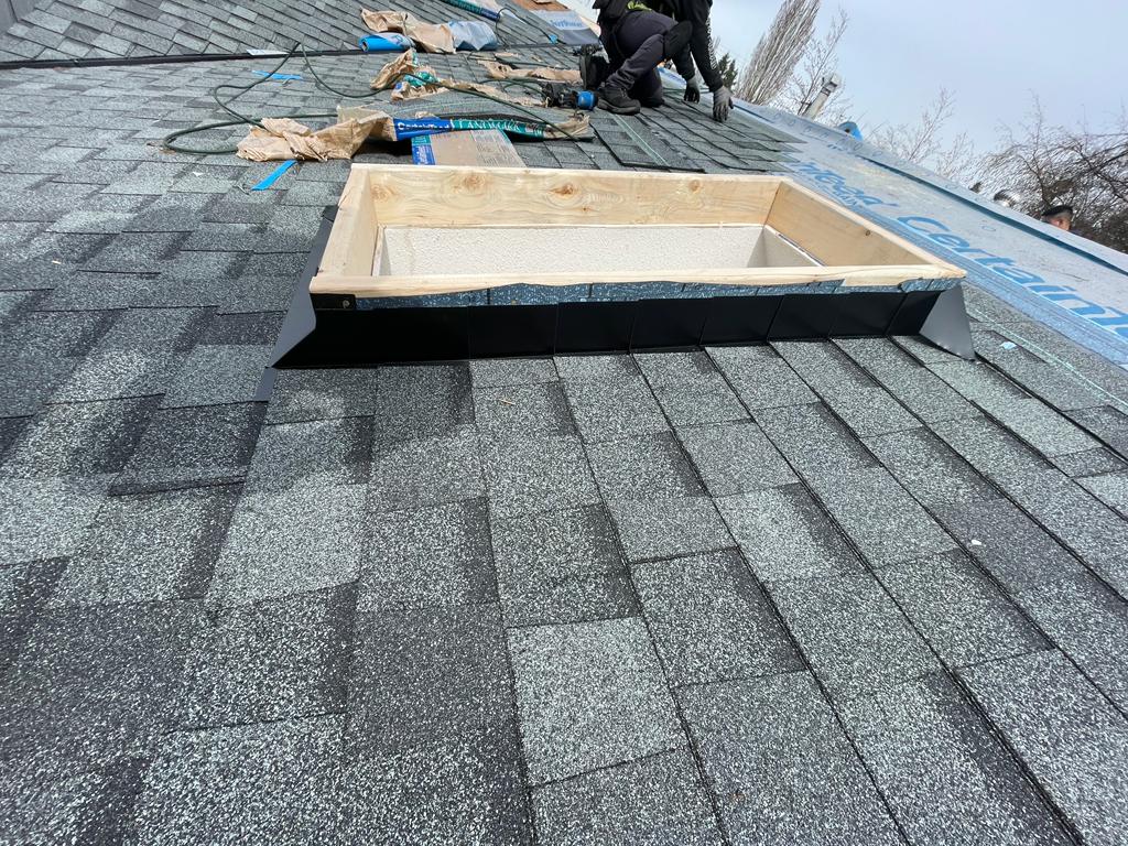 two men working on the roof of a house.