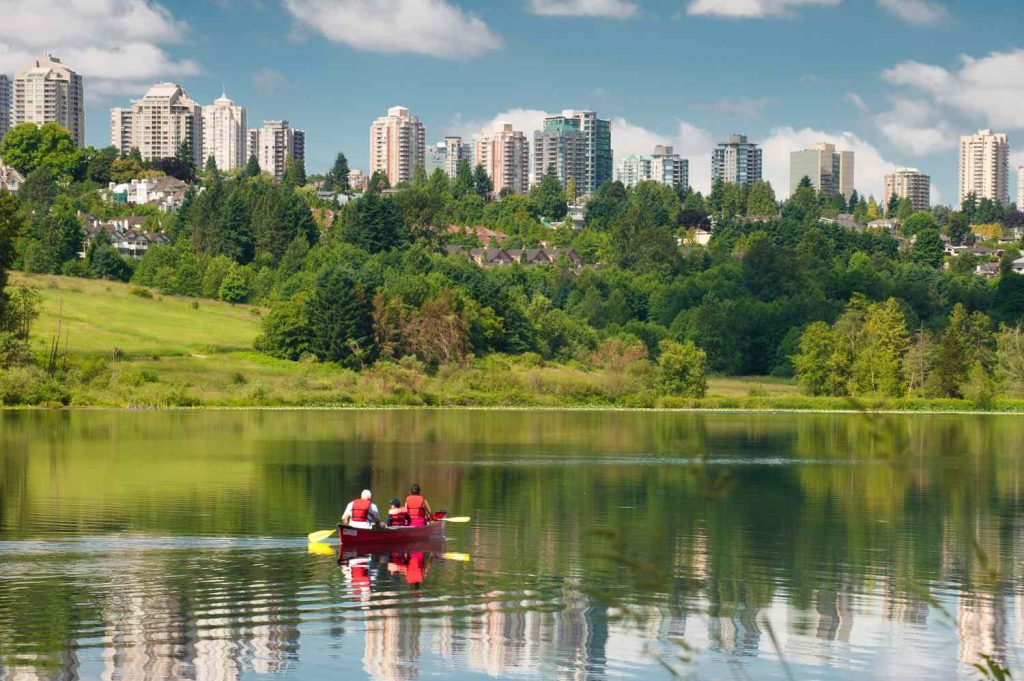 Two people paddling a canoe on a lake in Burnaby, best roofers in Burnaby paragon roofing BC.