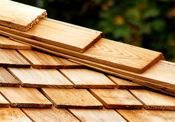 A close up of a wooden shingle on a roof, showcasing the craftsmanship of Paragon Roofing BC.