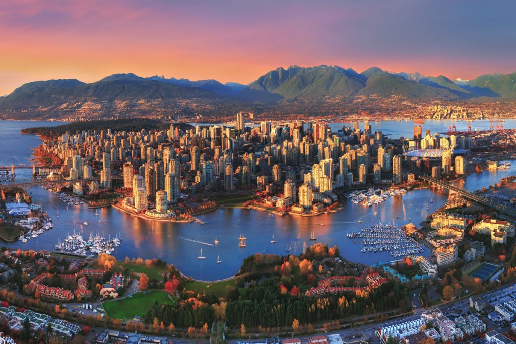 An aerial view of the city of Vancouver at sunset, served by paragon roofing, best roofers in vancouver