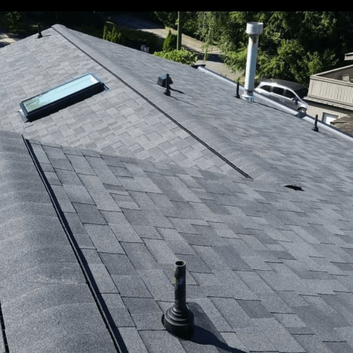 An aerial view of a roof with shingles, showcasing the craftsmanship of the best roofers in Vancouver.